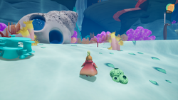 Small screenshot of Mu and The Little Reef showing Mu, the main character, standing in the reef surrounded by colorful coral, an eel, and a conch shell house with a door and window.